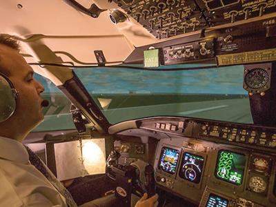 pilot at flight deck controls