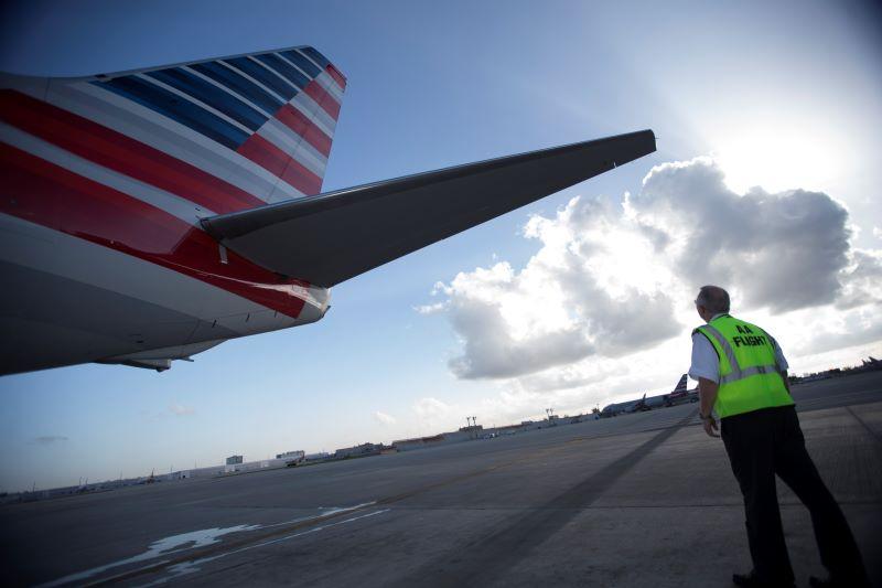 American Airlines pilot checking tail before flight