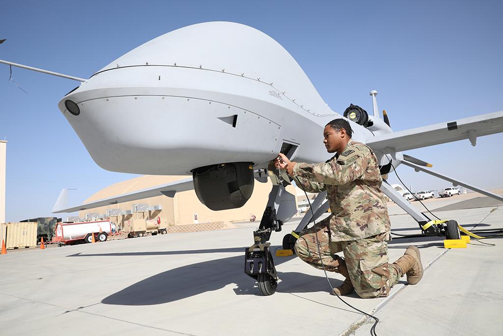 soldiers performing maintenance on an MQ-1 Gray Eagle