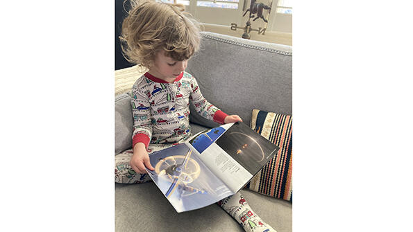 Katie Martin's son JW glancing through AW&ST