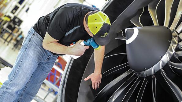 GE technician working on fan blade