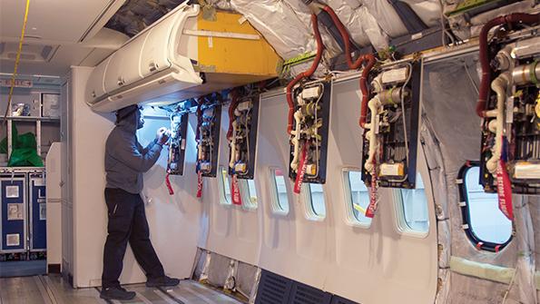 Man inspecting aircraft cabin 