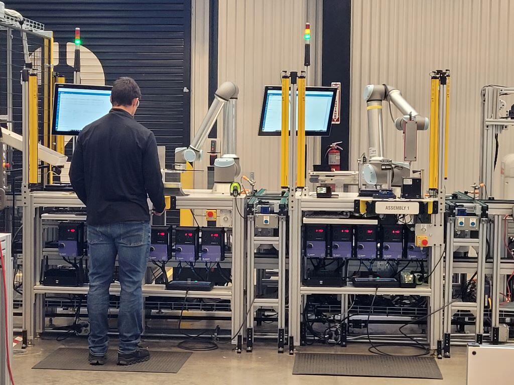 Robots and workers manufacture products