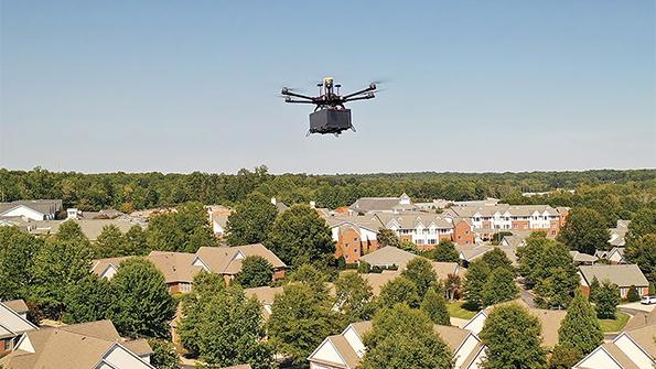 UAS transporting package over residential neighborhood