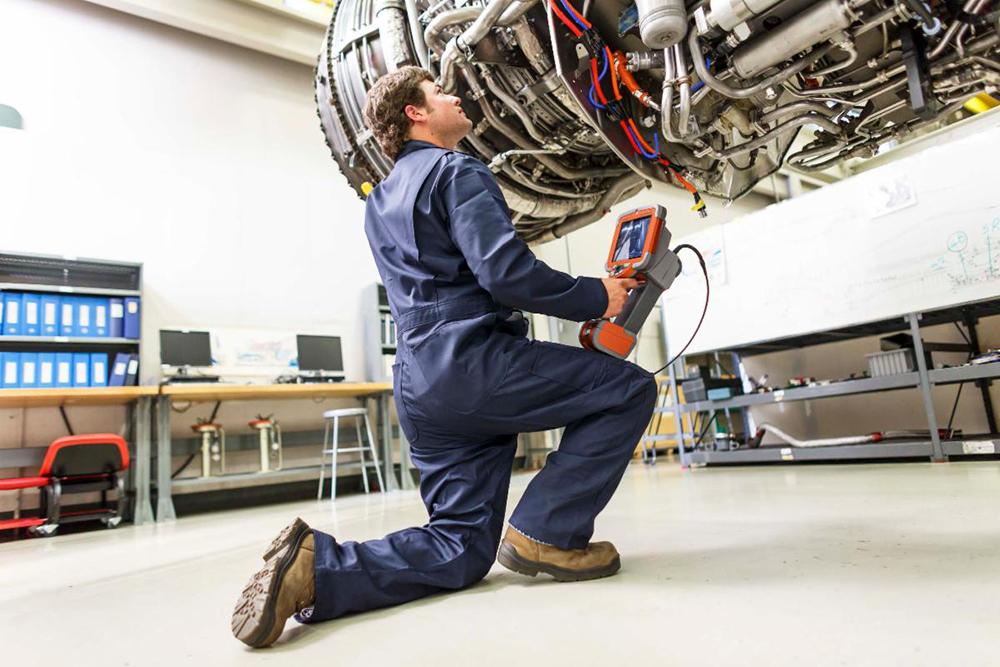 Technician performing a borescope inspection