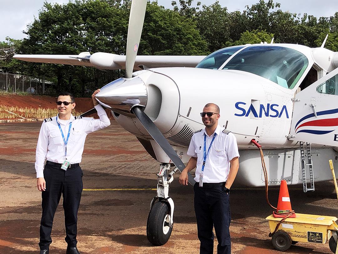 Capt. Andrés Esquivel (right) and co-pilot Alfredo Sanchez with a Sansa Airlines Cessna Grand Caravan 208B EX at Cóbano Airport, Costa Rica