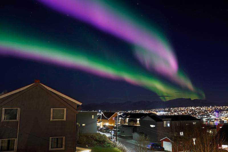 Tromsø, Norway with aurora borealis overhead