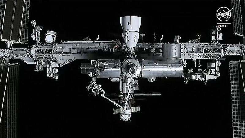 The station is viewed from the approaching SpaceX Dragon cargo spacecraft. The SpaceX Dragon Endurance crew spacecraft is pictured docked at center top