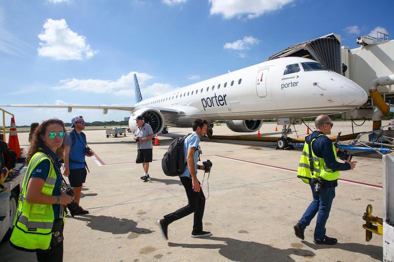 porter e195-e2 with people on tarmac