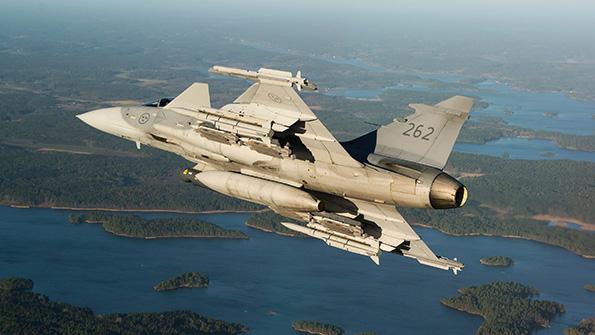 saab gripen in flight carrying weapons