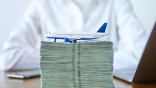 money and toy plane