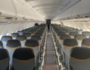 Aircraft cabin showing additional rows of new, slimmer seats