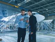 aerospace industry executives in aircraft hangar